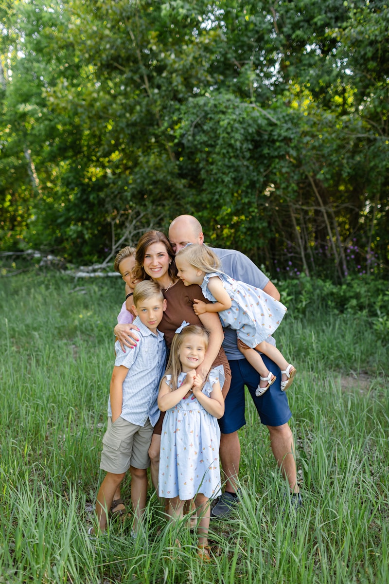 a family poses for a picture in a field